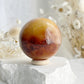 CARNELIAN SPHERE APPROX 5.5CM. STONED AND SAGED AUSTRALIA.