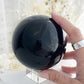 BLACK OBSIDIAN SPHERE. APPROX 9.5CM. STONED AND SAGED AUSTRALIA.