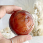 CARNELIAN SPHERE APPROX 6.1CM. STONED AND SAGED AUSTRALIA.