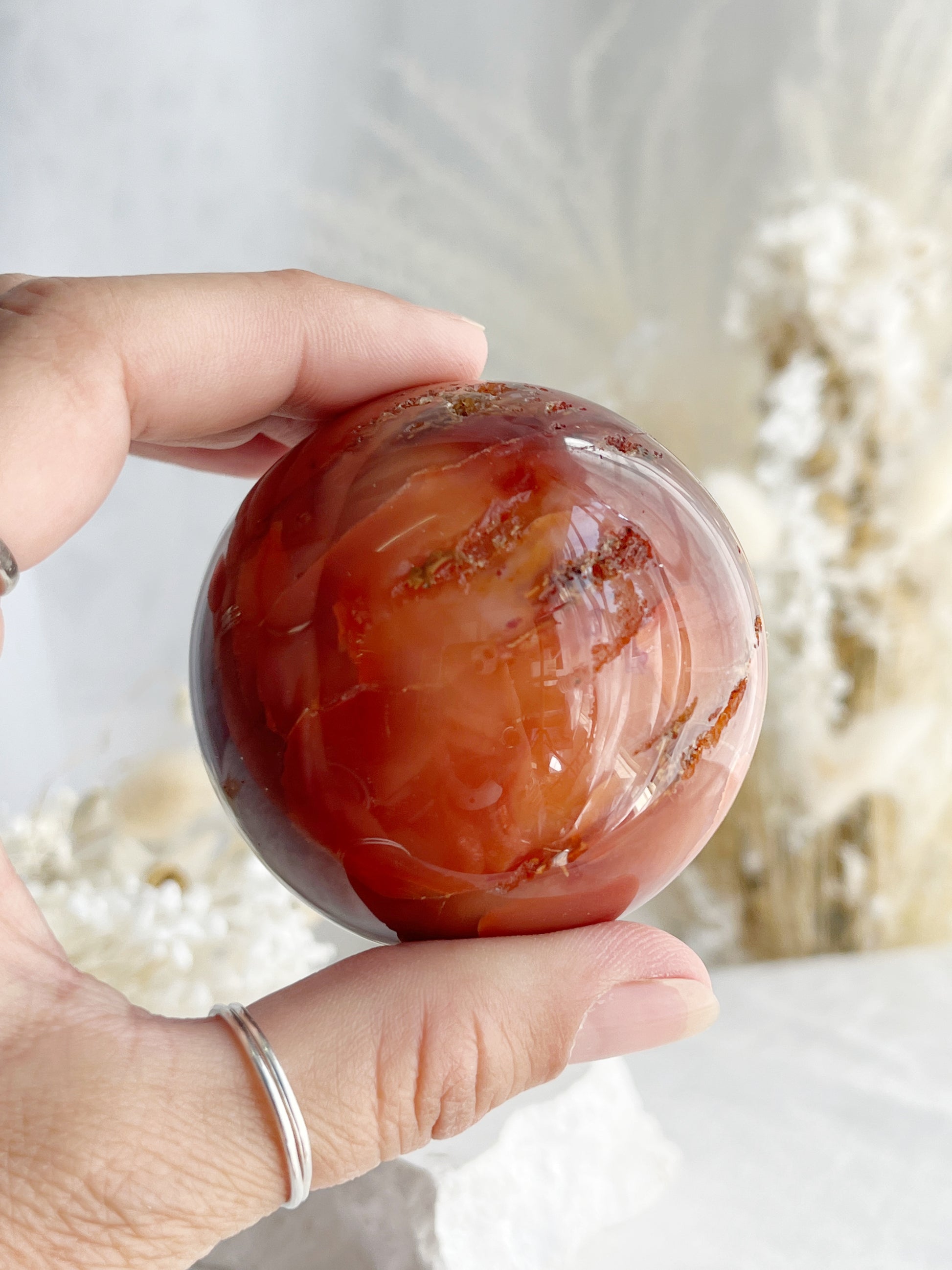 CARNELIAN SPHERE APPROX 6.1CM. STONED AND SAGED AUSTRALIA.