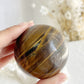 TIGERS EYE SPHERE APPROX 6.1CM. STONED AND SAGED AUSTRALIA.