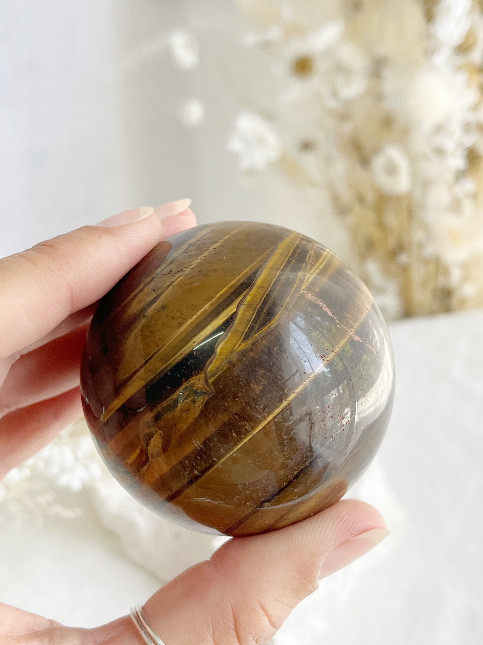 TIGERS EYE SPHERE APPROX 6.1CM. STONED AND SAGED AUSTRALIA.