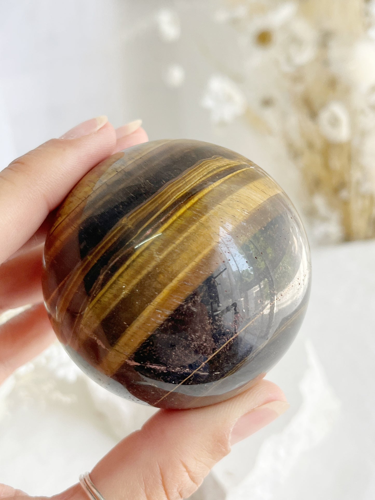 TIGERS EYE SPHERE APPROX 6.1CM. STONED AND SAGED AUSTRALIA.