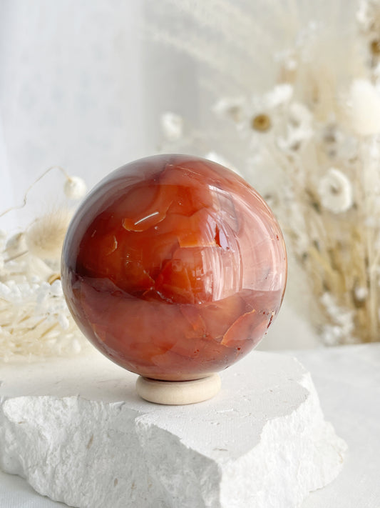 CARNELIAN SPHERE APPROX 6.1CM. STONED AND SAGED AUSTRALIA.