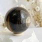 TIGERS EYE SPHERE APPROX 6.1CM. STONED AND SAGED AUSTRALIA.