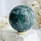 MOSS AGATE SPHERE APPROX 6.4CM. STONED AND SAGED AUSTRALIA.