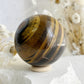 TIGERS EYE SPHERE APPROX 6.1CM. STONED AND SAGED AUSTRALIA.