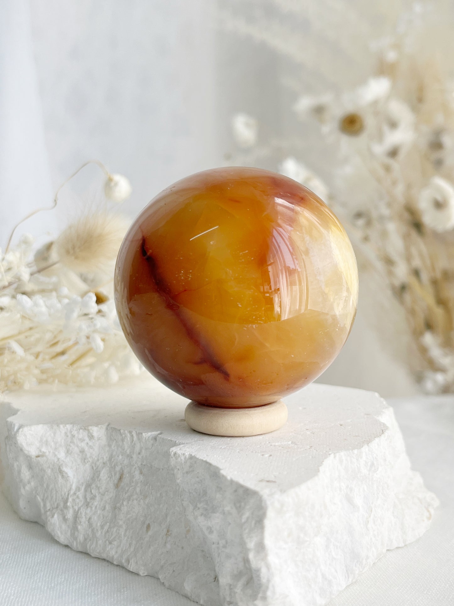 CARNELIAN SPHERE APPROX 5.5CM. STONED AND SAGED AUSTRALIA.