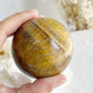 TIGERS EYE SPHERE APPROX 6.4CM. STONED AND SAGED AUSTRALIA.