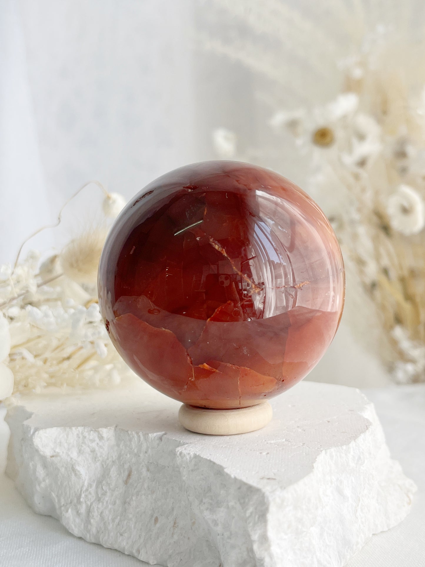 CARNELIAN SPHERE APPROX 6.1CM. STONED AND SAGED AUSTRALIA.