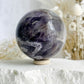 DREAM AMETHYST SPHERE APPROX 7CM. STONED AND SAGED AUSTRALIA.